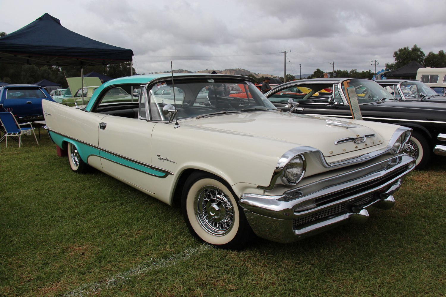 Two-tone 2-door coupe with chrome accents and vintage wire wheels