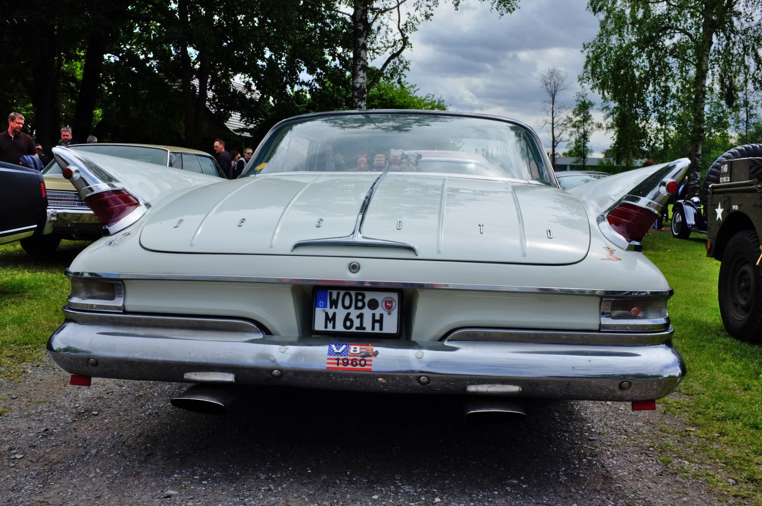 Large tailfins with integrated rear lights and wide chrome bumper with dual exhaust