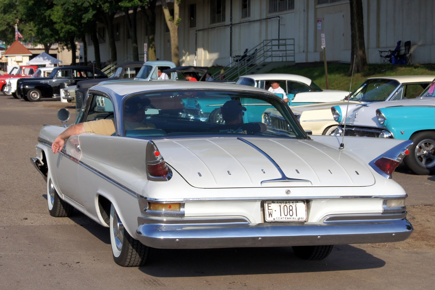 Rear view of a vintage 2-door hardtop with prominent tailfins and chrome bumper.