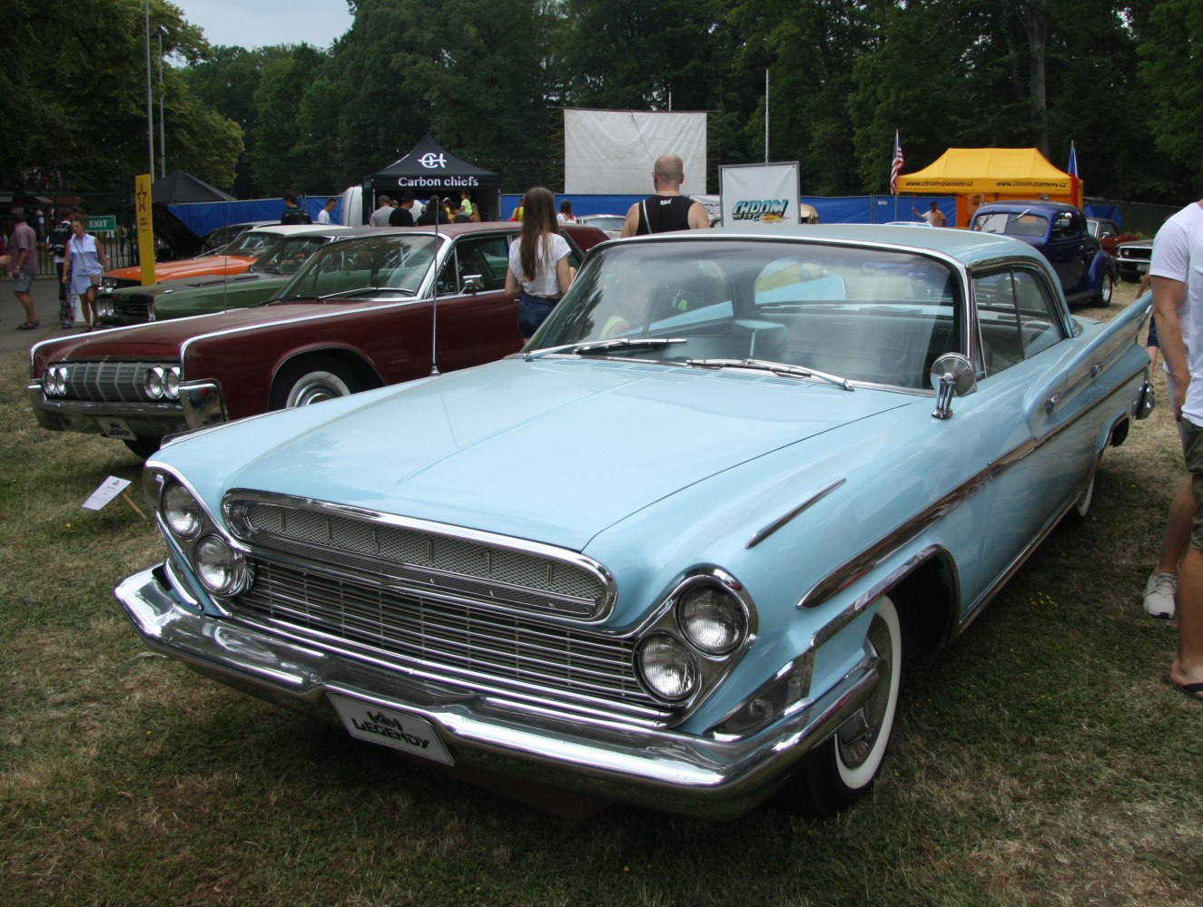 Light blue 4-door hardtop with chrome grille and dual round headlights