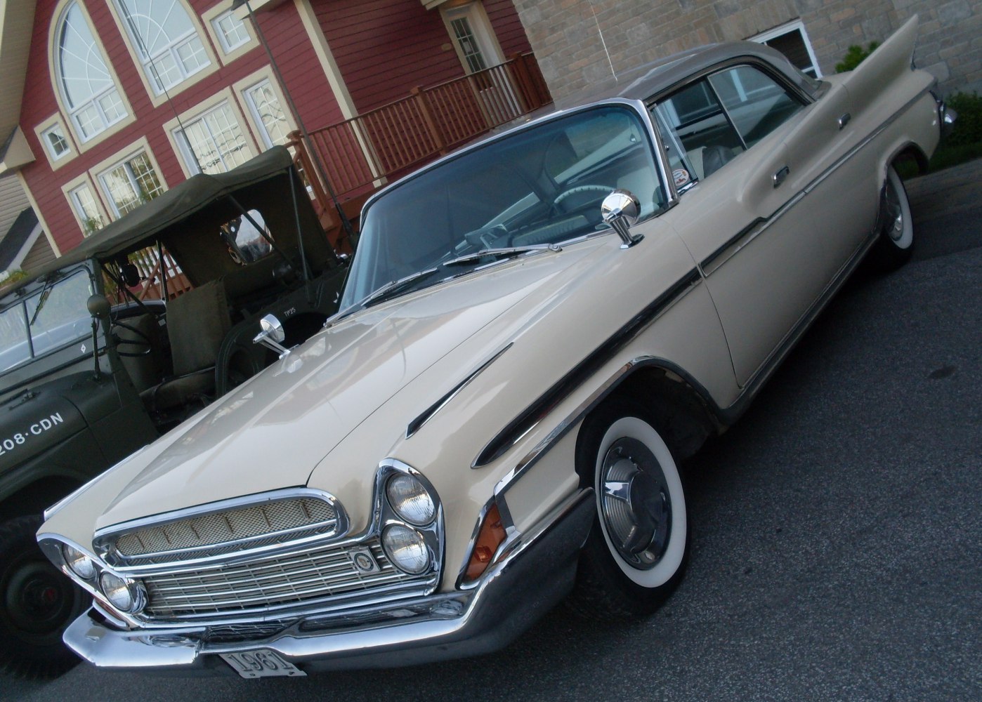 Dual headlights, chrome grille, whitewall tires, and hardtop sedan profile