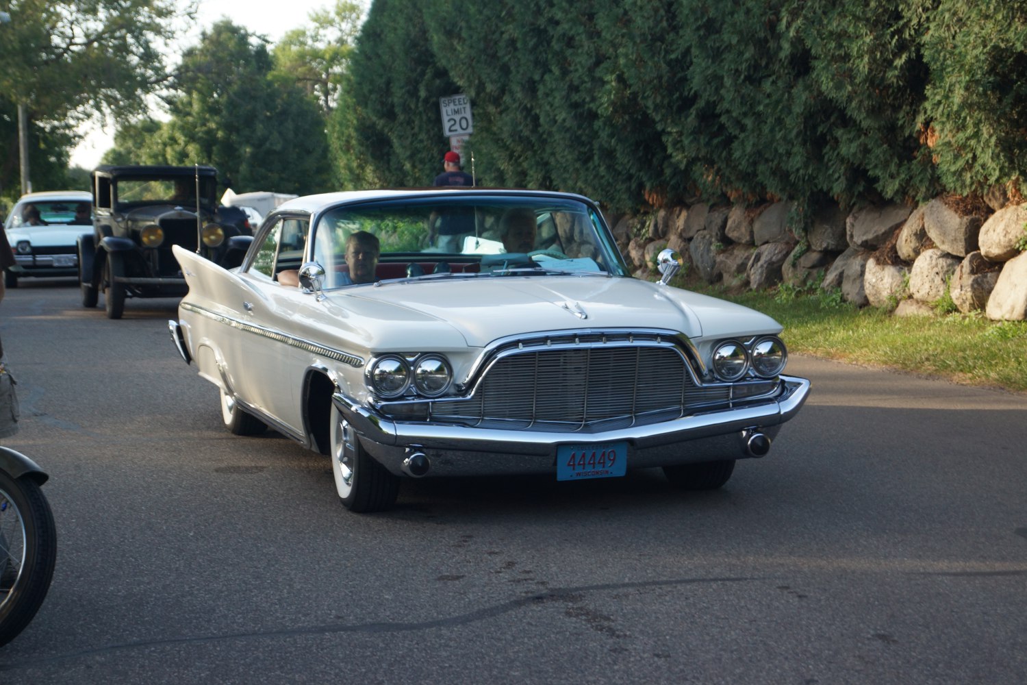 2-door hardtop with large chrome grille, dual round headlights, and pronounced tailfins
