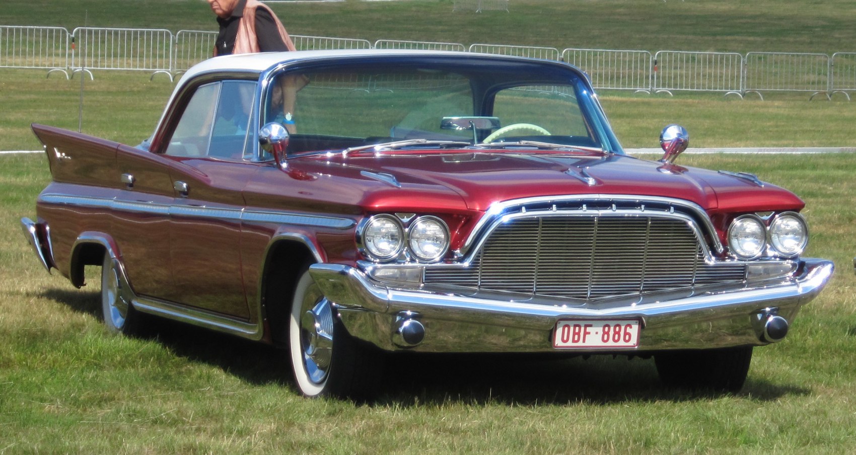 4-door hardtop with prominent tailfins, dual round headlights, and wide chrome grille