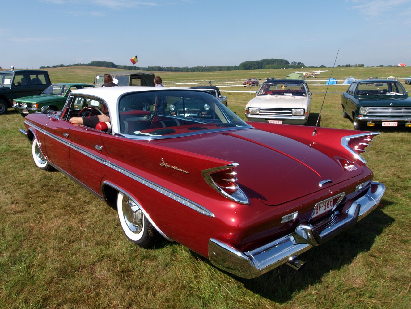 Classic 1960 hardtop car with big tailfins and chrome details.
