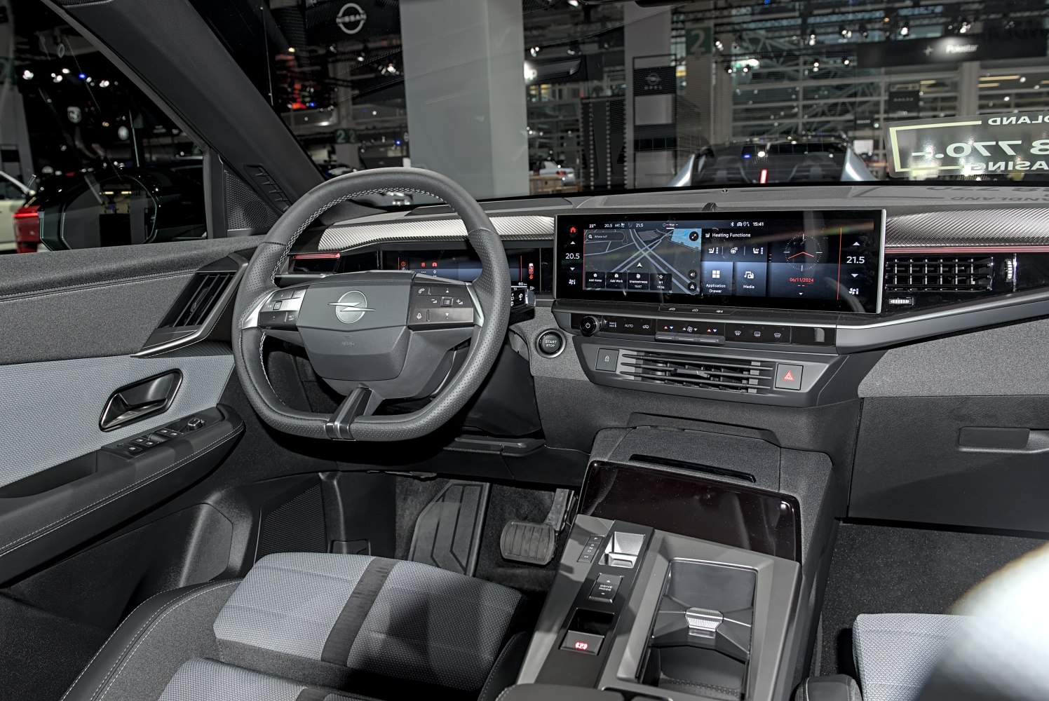 Digital instrument cluster and wide infotainment screen in car interior