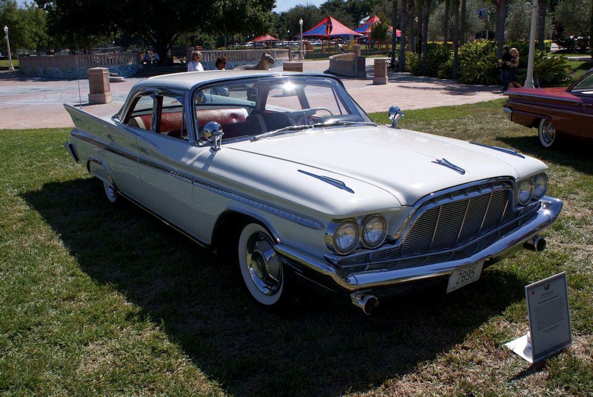 Vintage 4-door sedan with twin round headlights and distinctive tail fins
