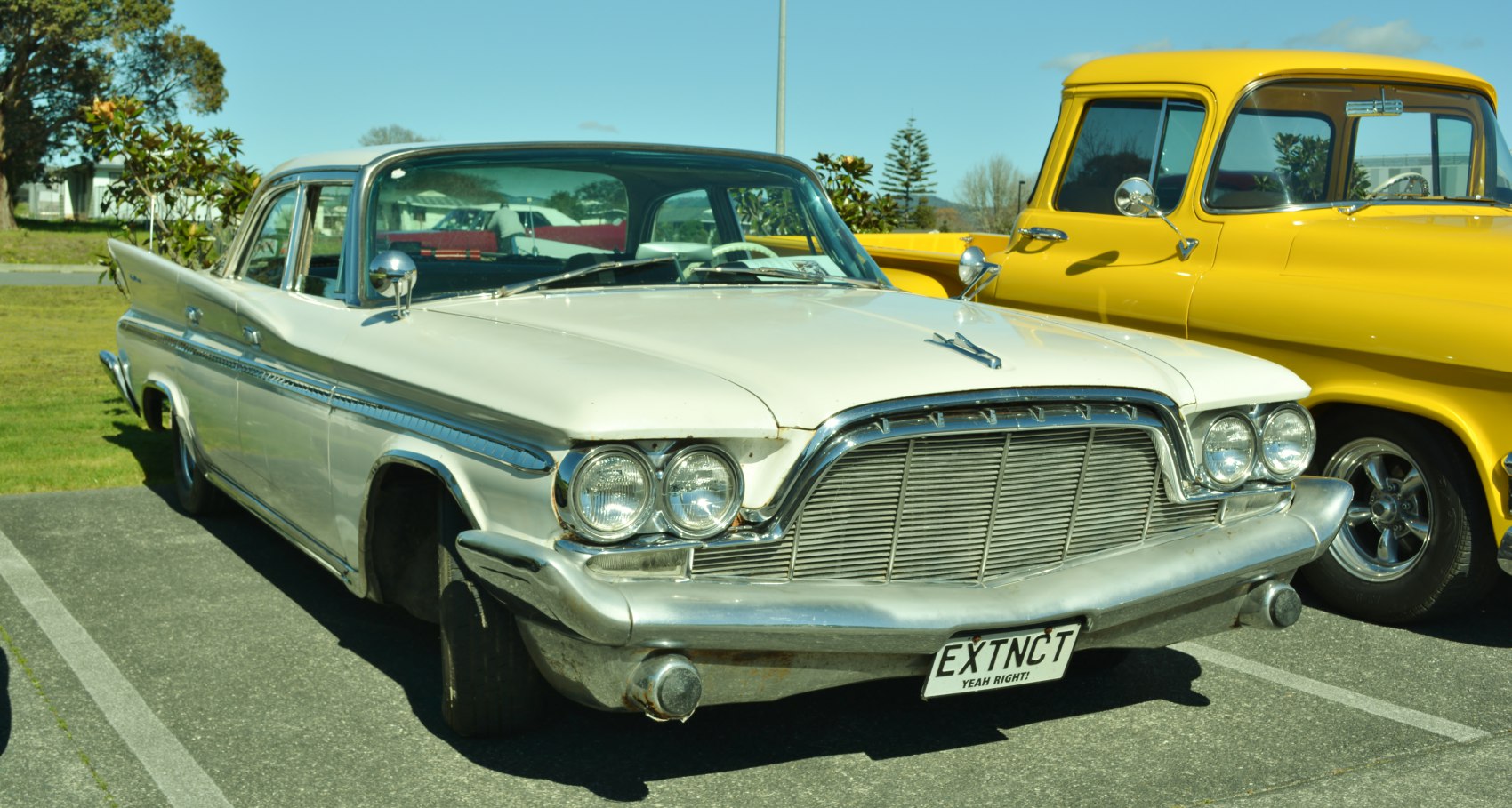 Vintage sedan front with dual round headlights and chrome grille