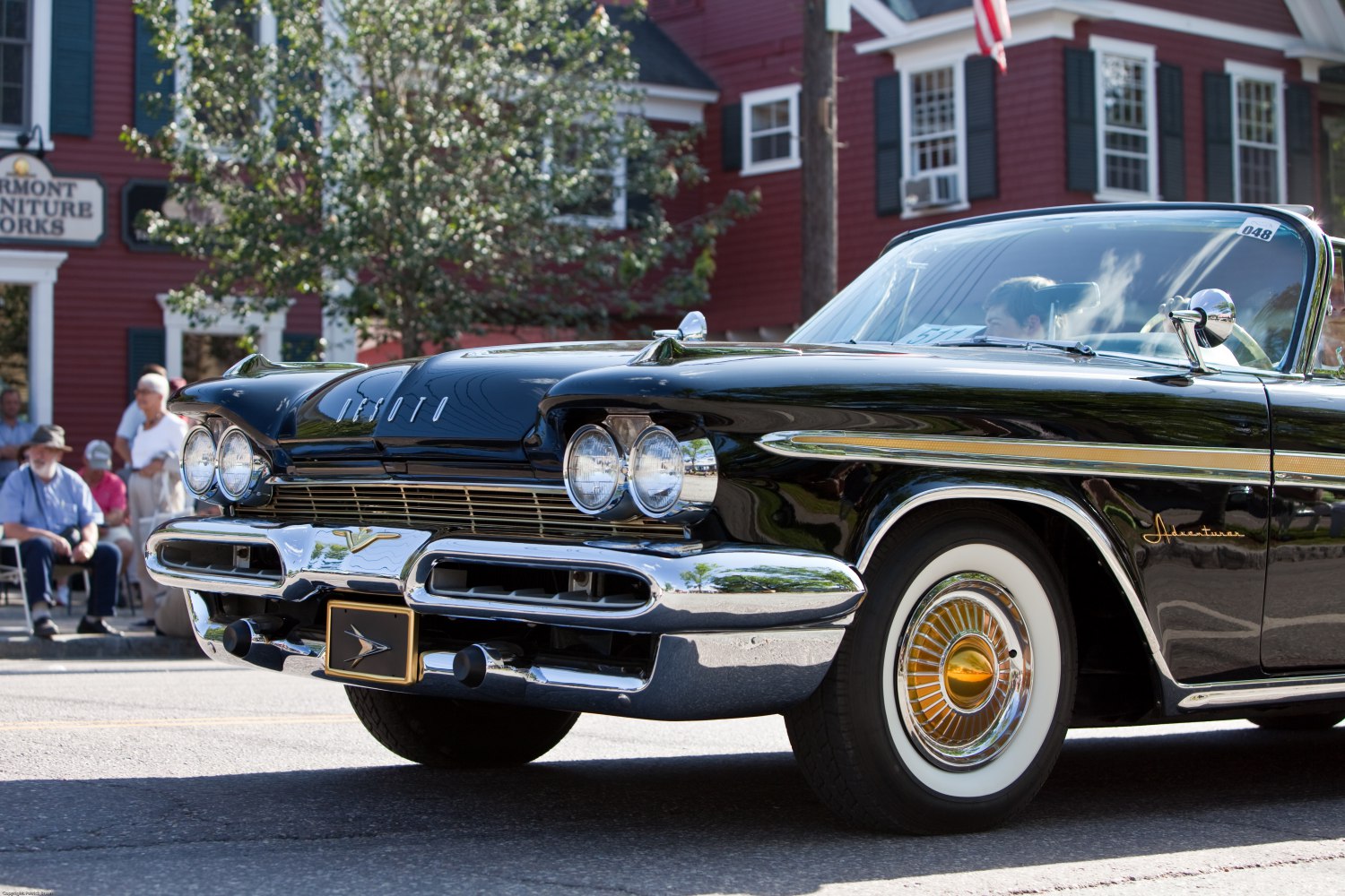 Classic car front end with dual round headlights and prominent chrome bumper