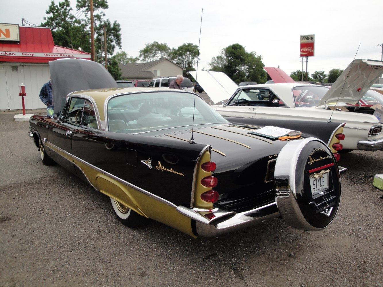 Rear view with tail fins and spare tire mount of classic 1950s coupe