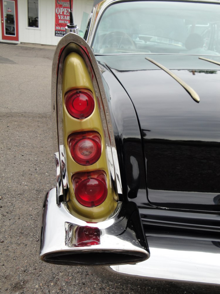 Vertical triple tail light assembly and chrome rear fin detail