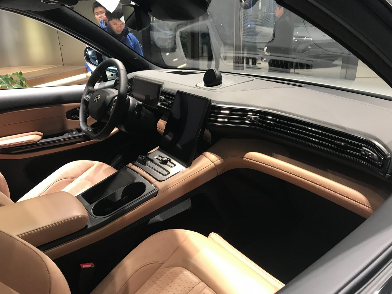 Modern dashboard with large touchscreen and tan leather seats