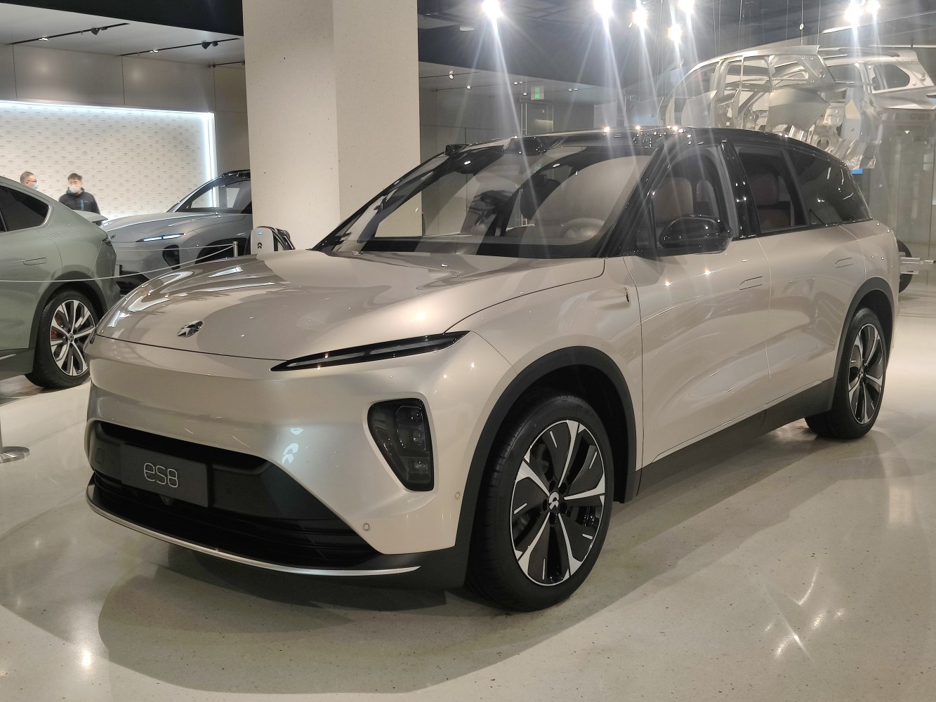 Front side view of a sleek electric SUV with sharp headlights and alloy wheels