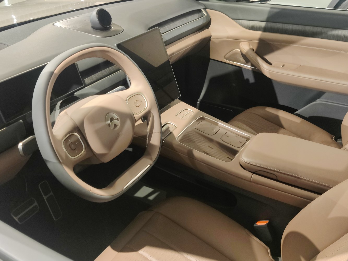 Modern steering wheel with central touchscreen in a luxury electric SUV interior