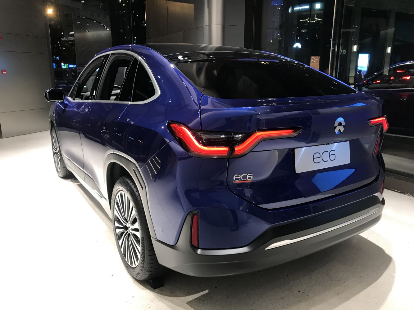 Rear view with distinctive LED taillights and sloping roofline