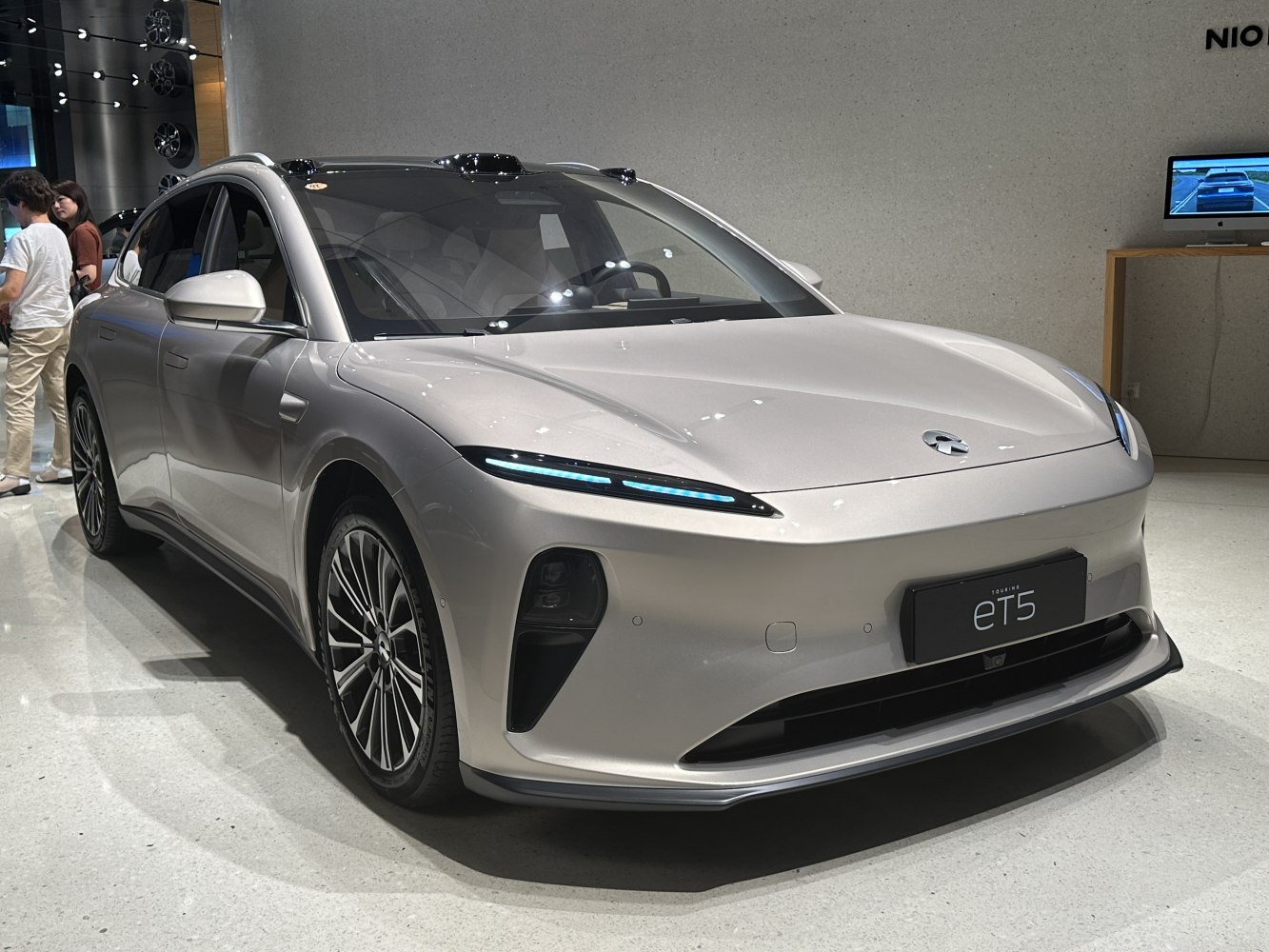 Electric sedan with slim LED headlights and multi-spoke wheels