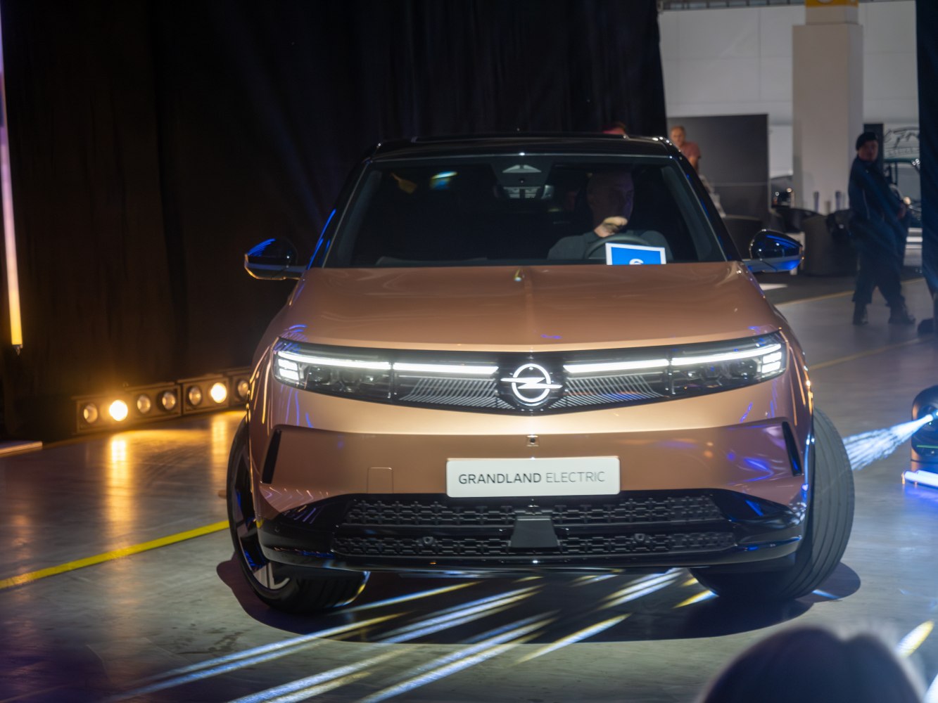 Front view of electric SUV with LED headlights and sleek grille