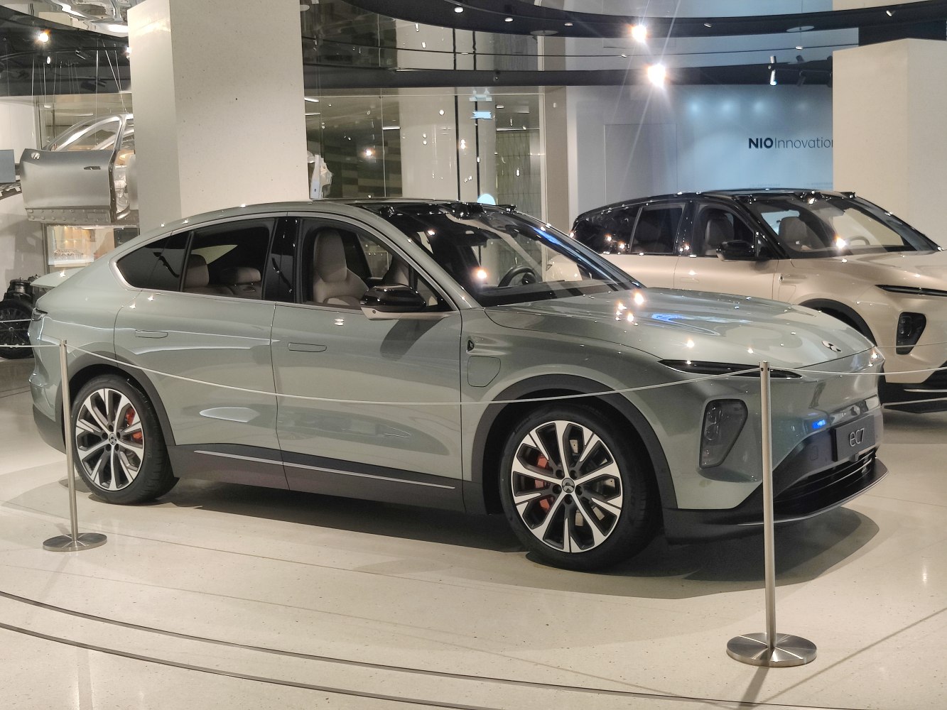 Sleek aerodynamic electric SUV with modern LED headlights and sporty multi-spoke wheels.