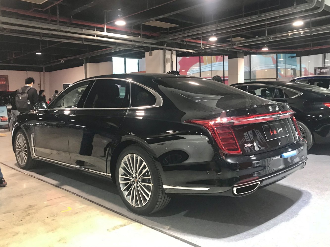 Luxury sedan rear and side with distinct rear lights and alloy wheels