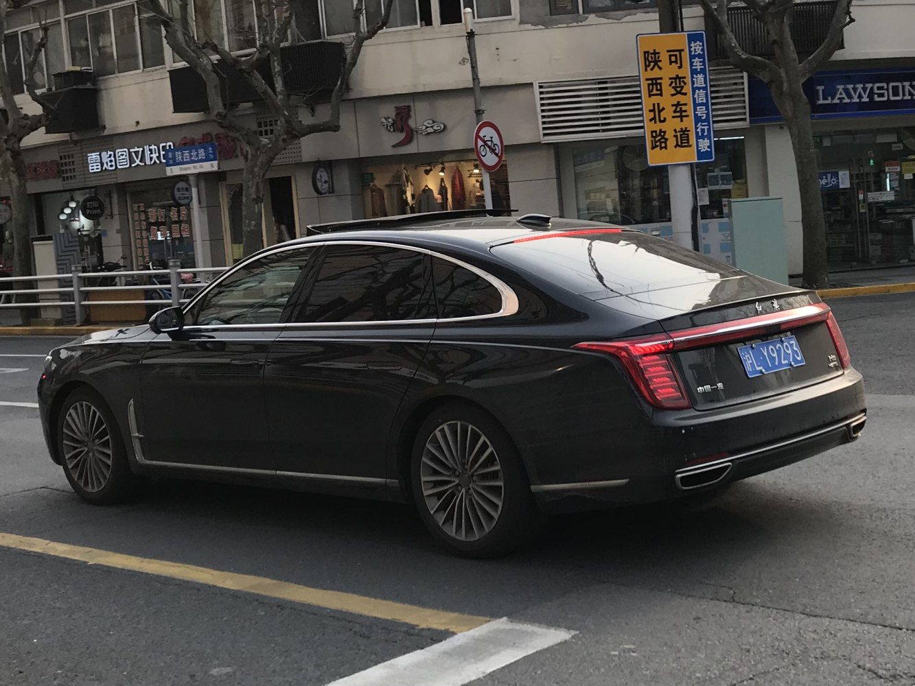 Luxury sedan rear and side profile with LED taillights and tinted windows