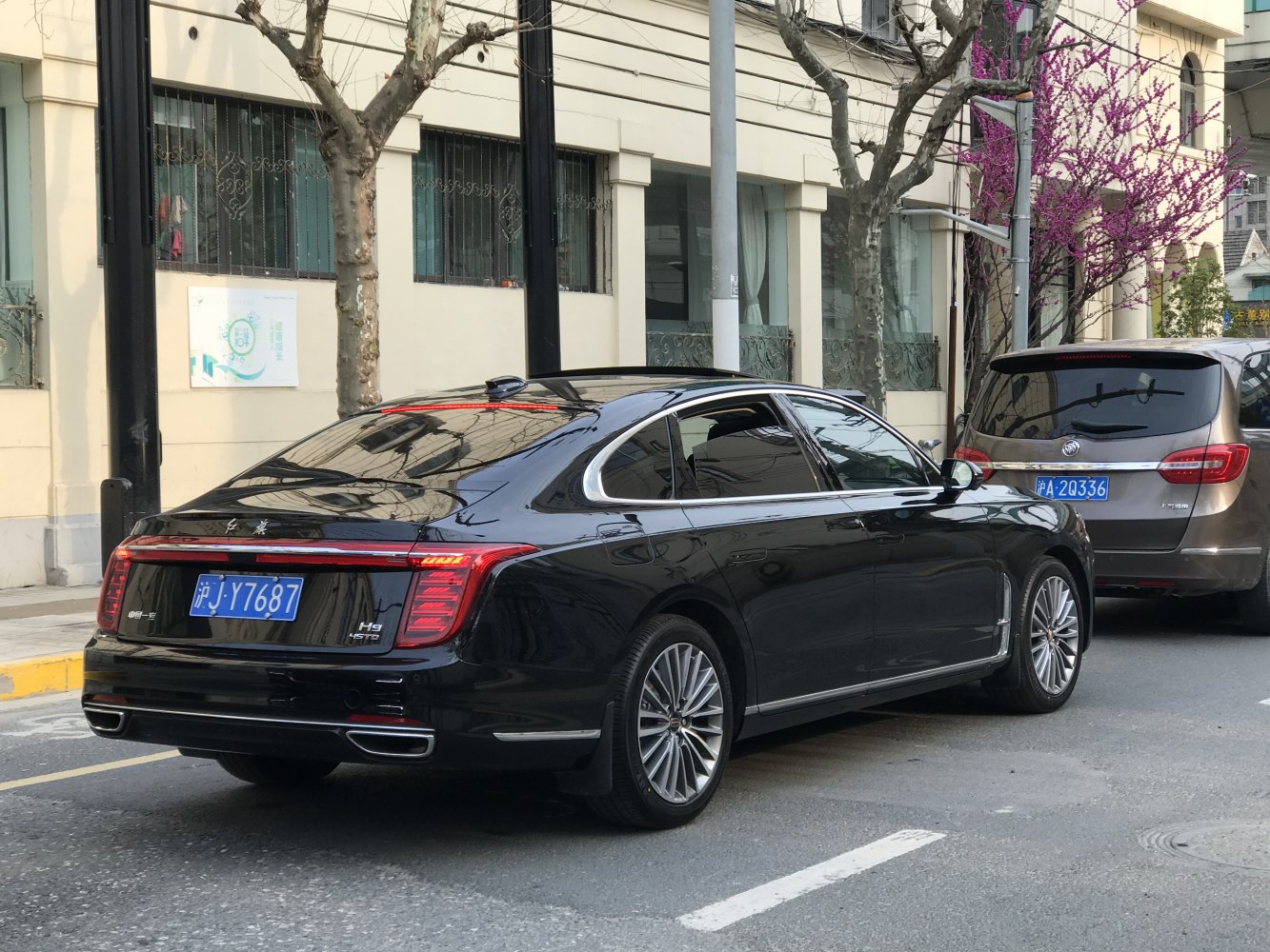 Rear view of luxury sedan with LED tail lights and chrome details