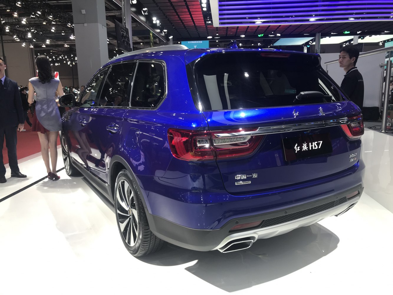Rear view of a blue SUV with distinctive taillights and dual exhaust tips