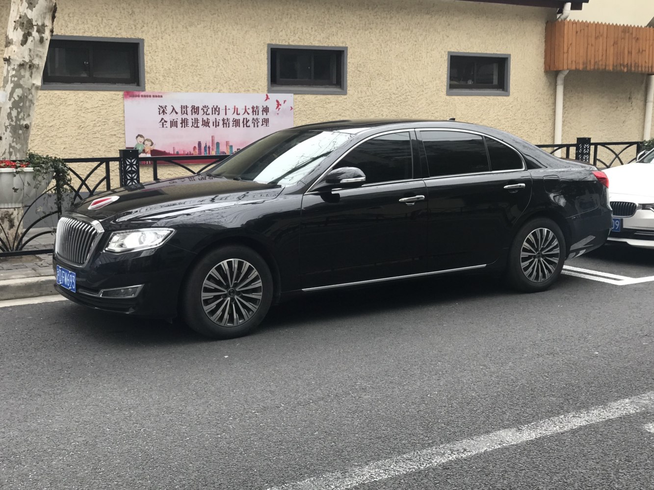 Black luxury sedan with vertical grill and alloy wheels