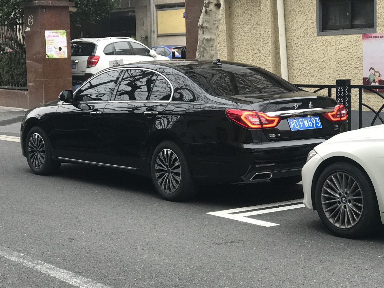 Luxury sedan rear with distinct taillights and integrated dual exhaust