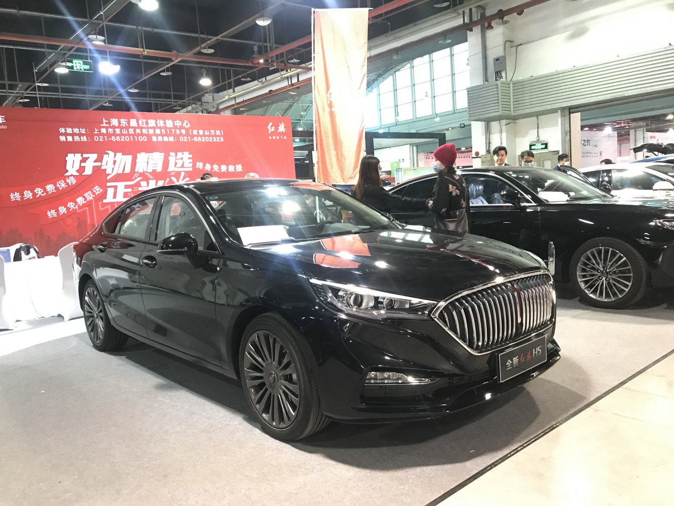 Black luxury sedan with chrome vertical grille and LED headlights