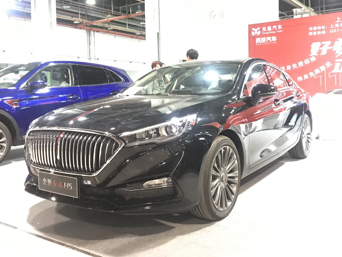 Front grille and LED headlights of a black luxury sedan