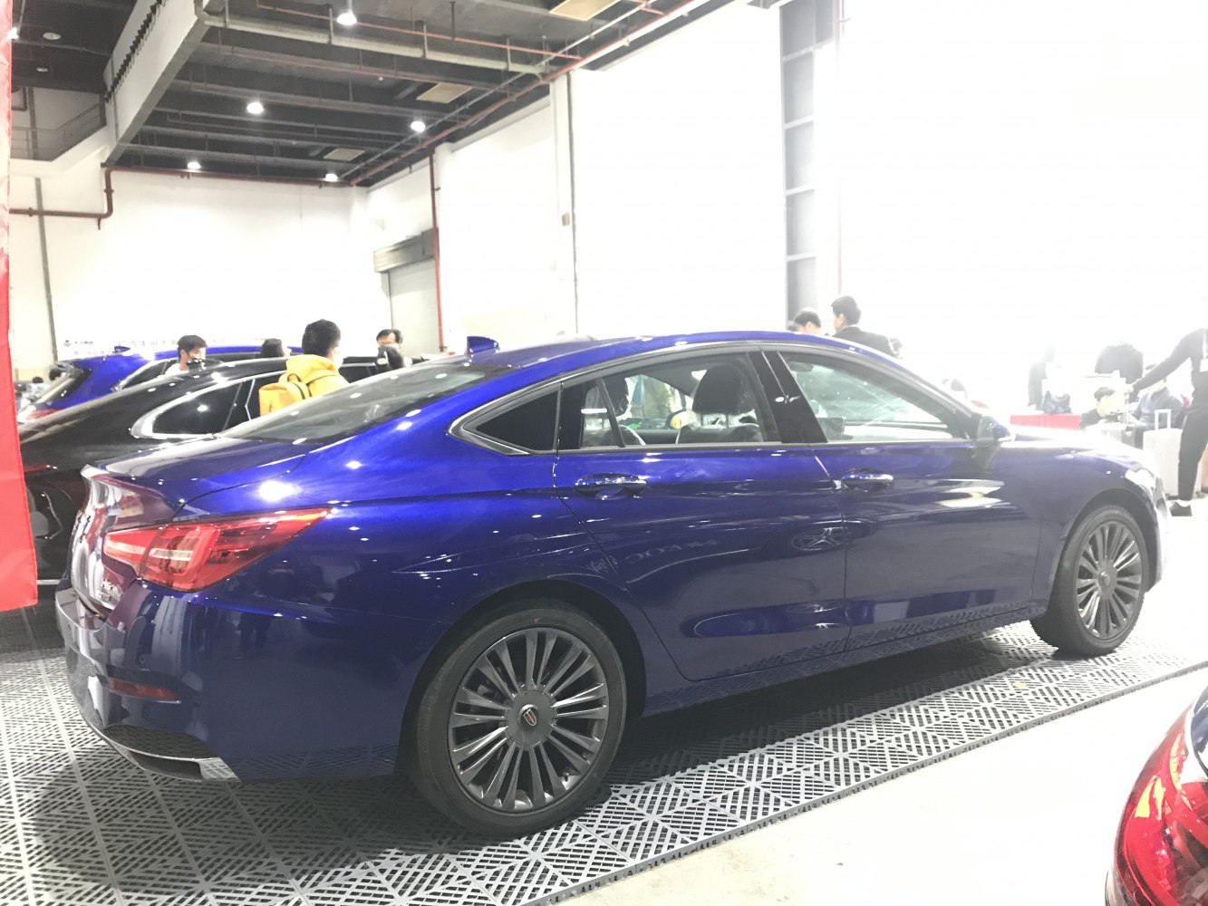 Sleek rear side profile with alloy wheels of a modern luxury sedan.