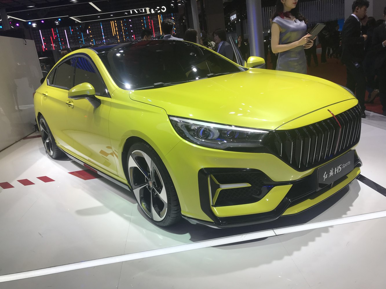 Bright yellow sedan front with bold grille and sporty headlights