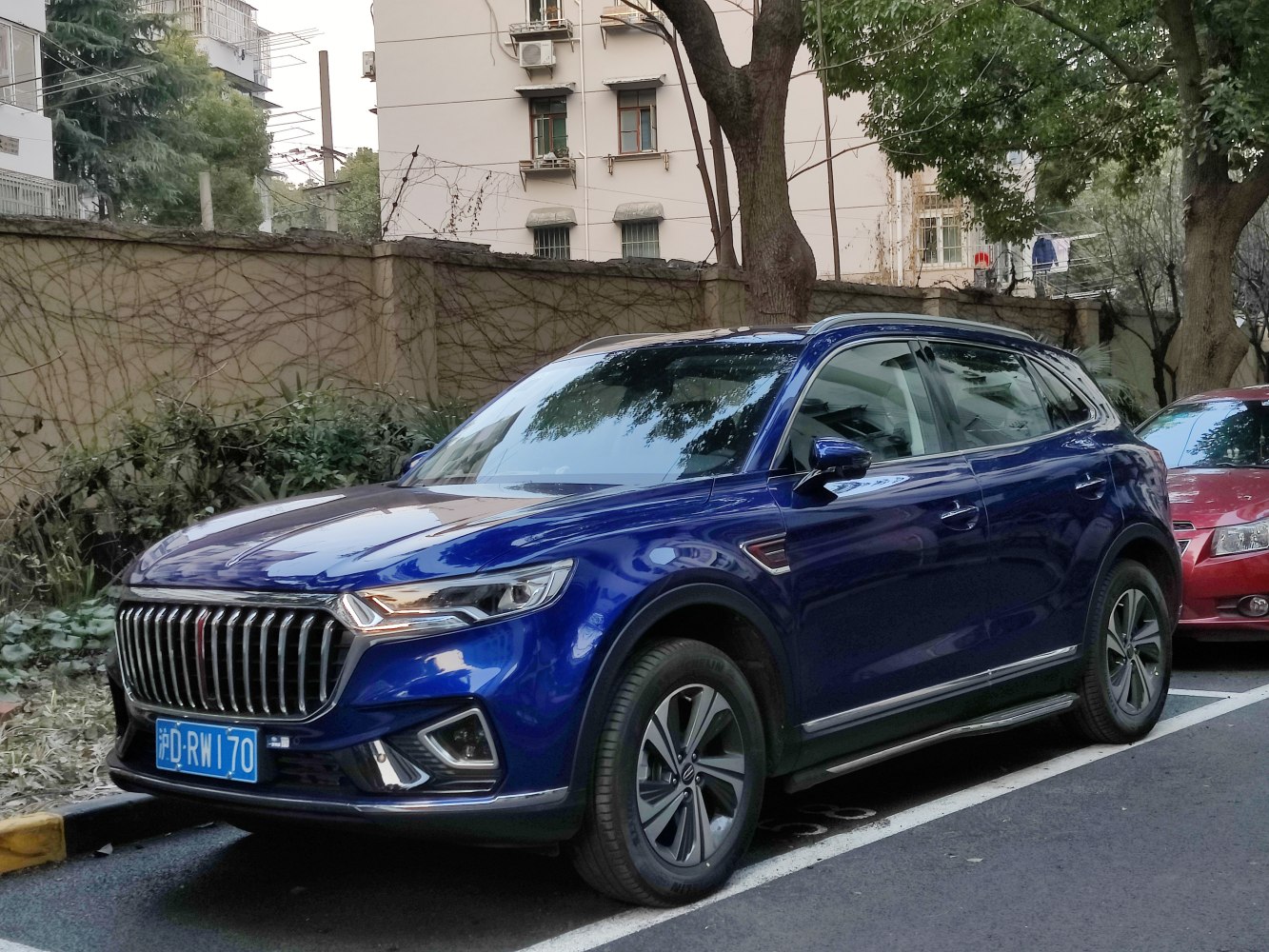 Blue SUV with vertical chrome grille and LED headlights