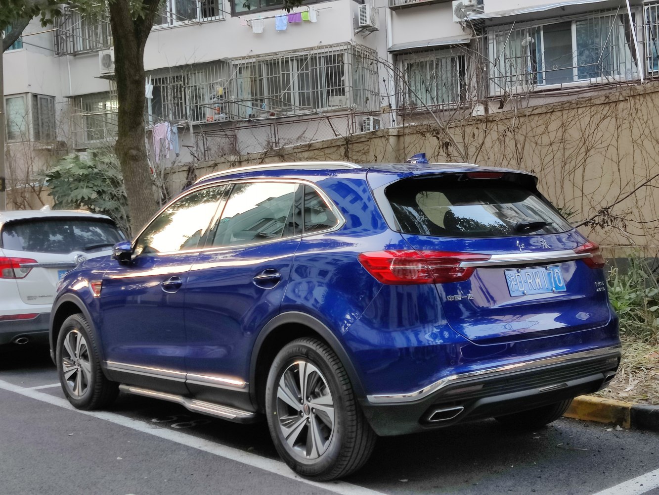 Rear side of blue SUV with modern tail lights and chrome trim