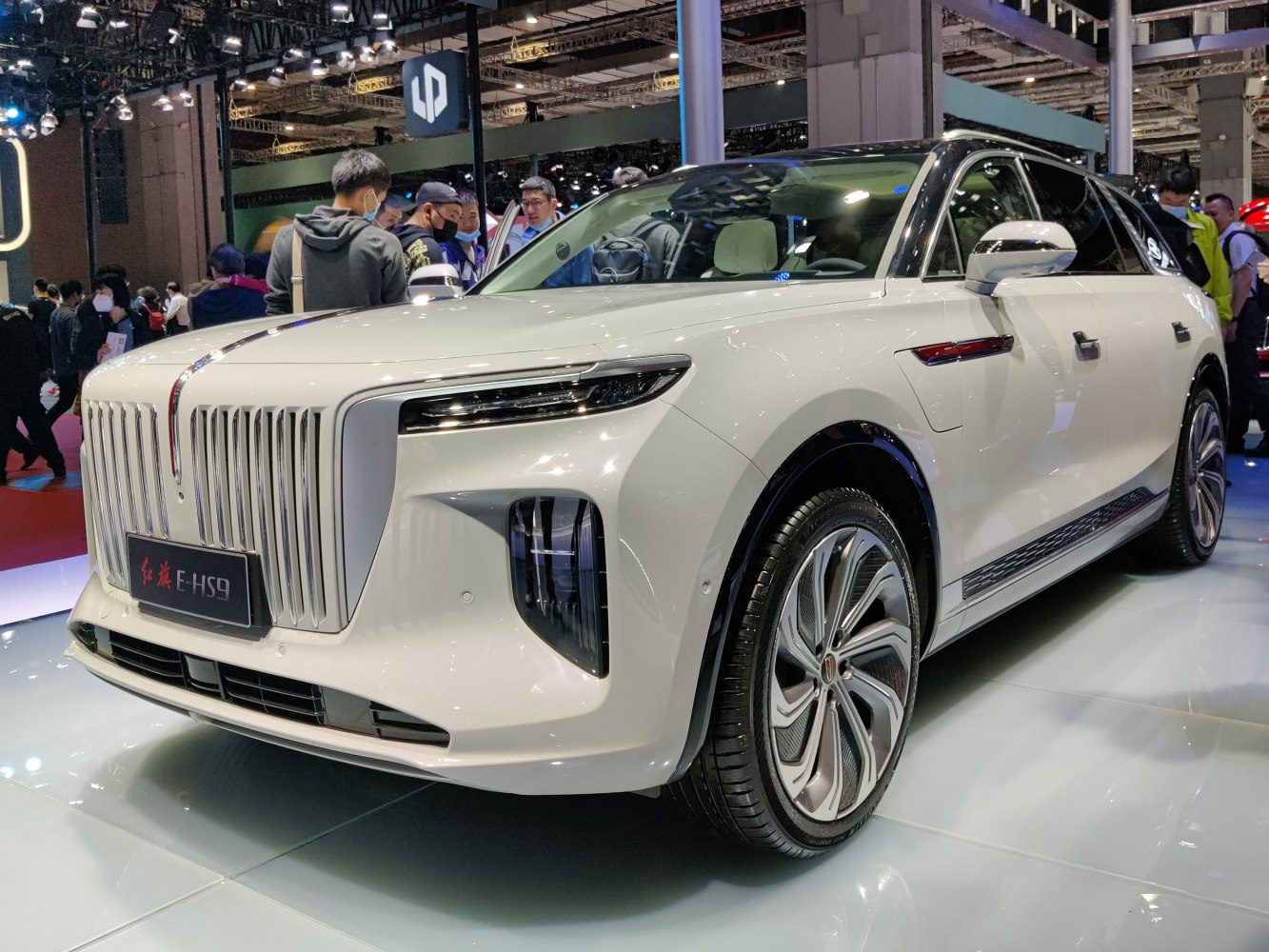 Prominent vertical grille and slim LED headlights on luxury SUV front.