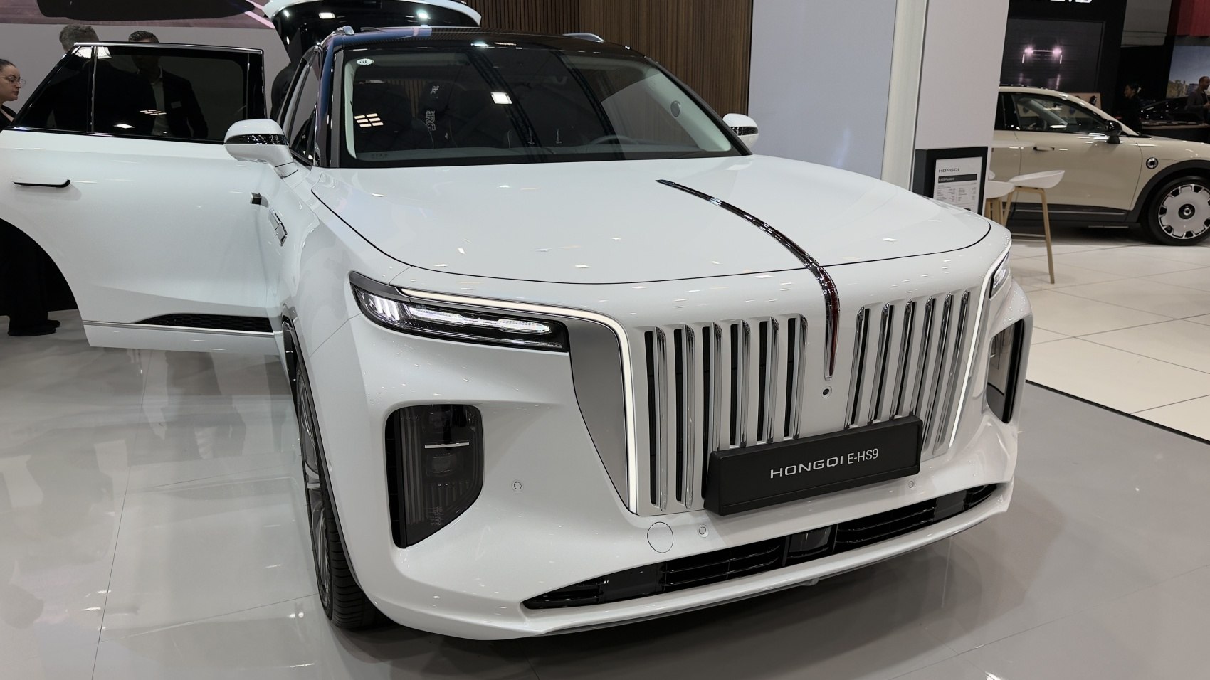 White luxury SUV with prominent vertical grille and slim LED headlights