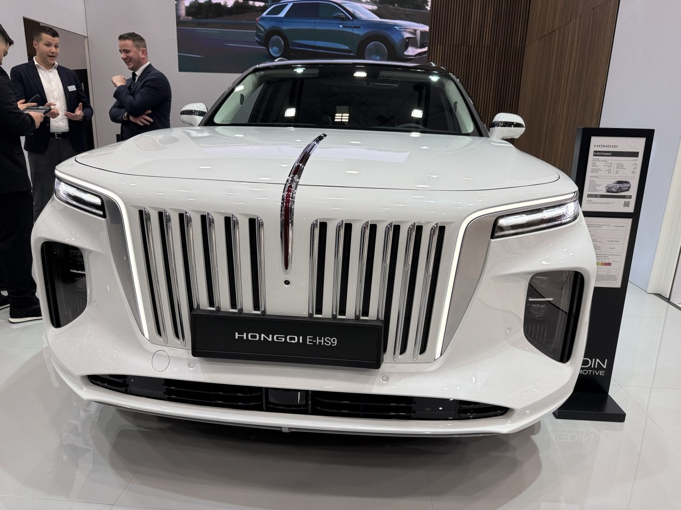 Prominent vertical grille with sleek LED headlights and front design.