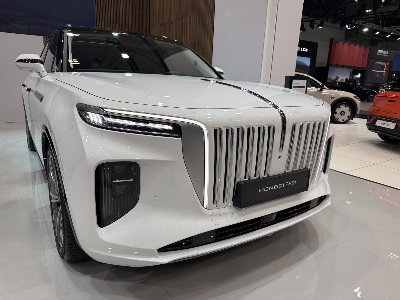 Prominent vertical chrome grille with slim LED headlights