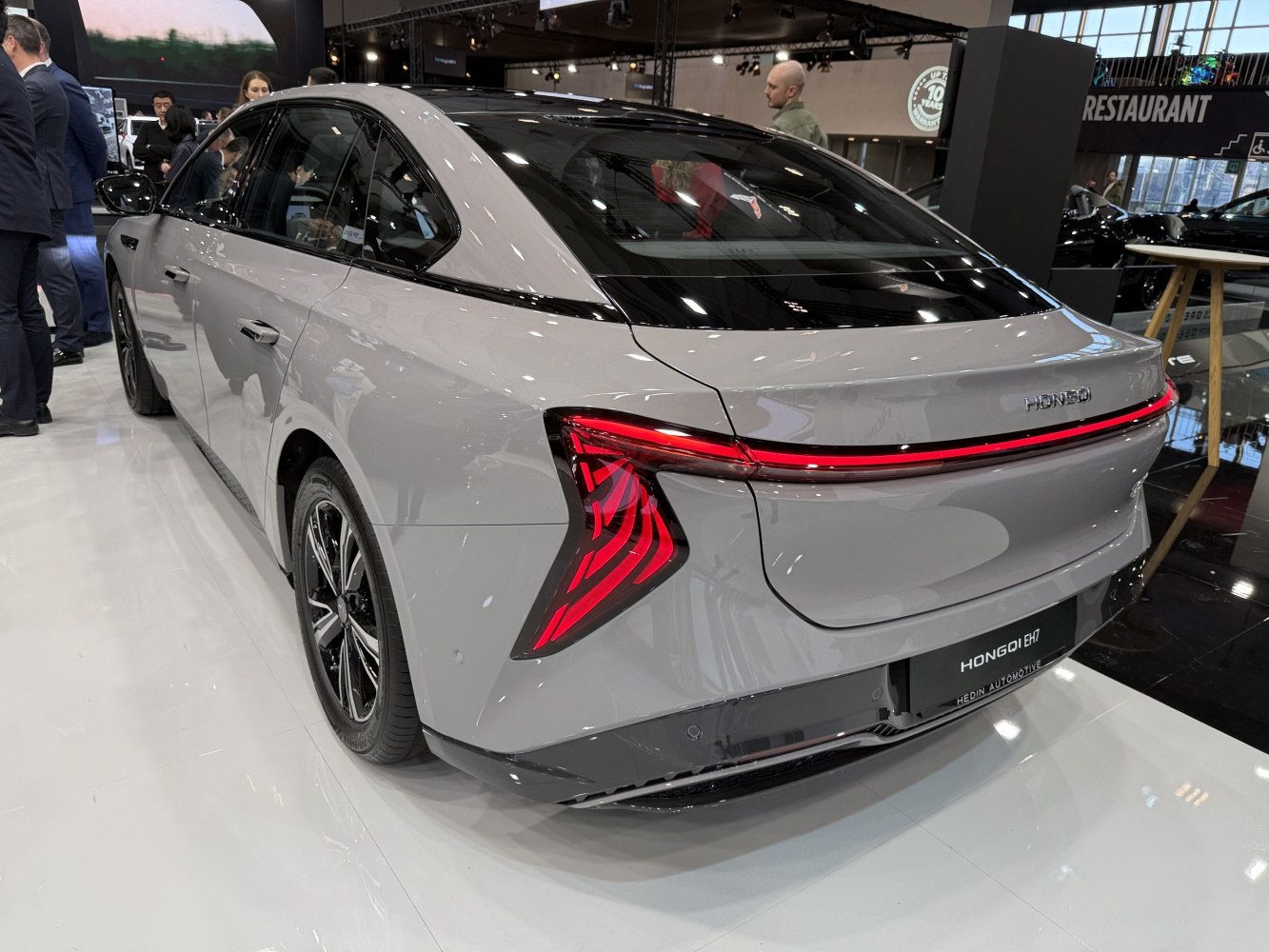 Sleek modern sedan rear with angular LED tail lights and continuous light bar