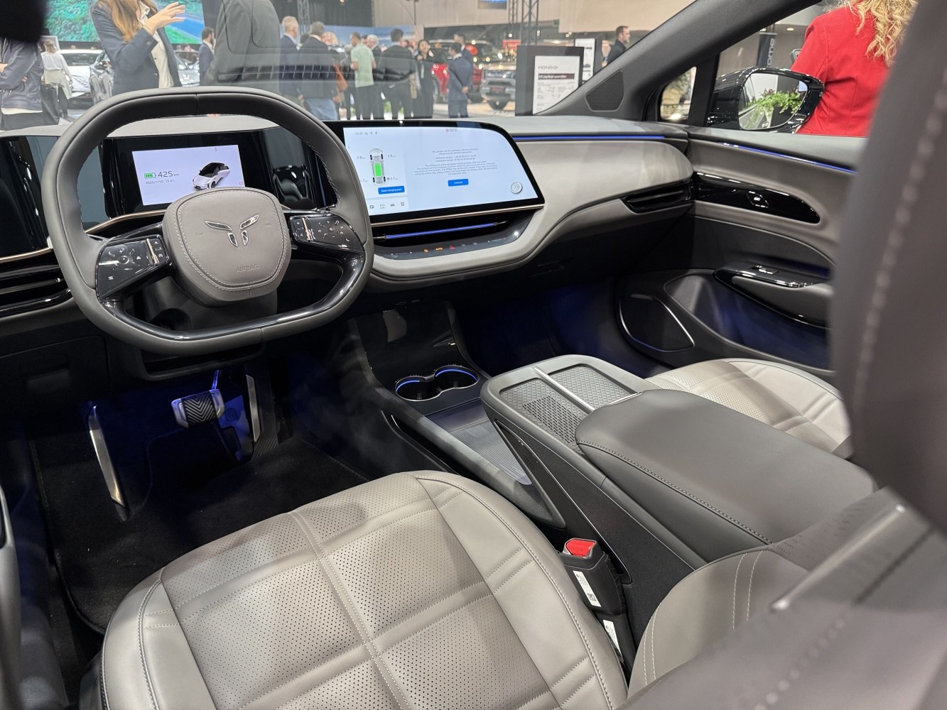 Electric car interior with dual digital displays and modern steering wheel