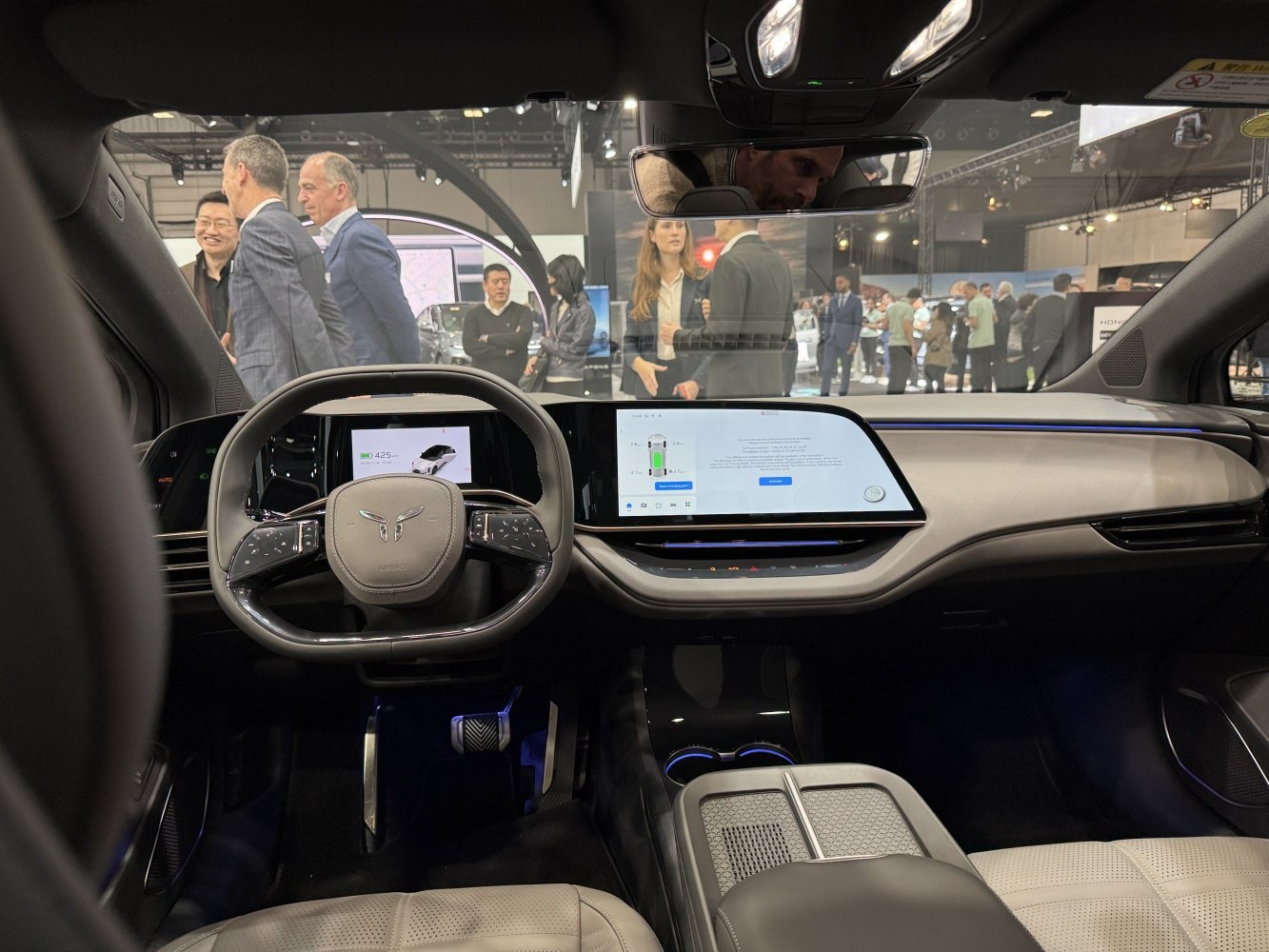 Dual digital displays and modern steering wheel in futuristic car interior
