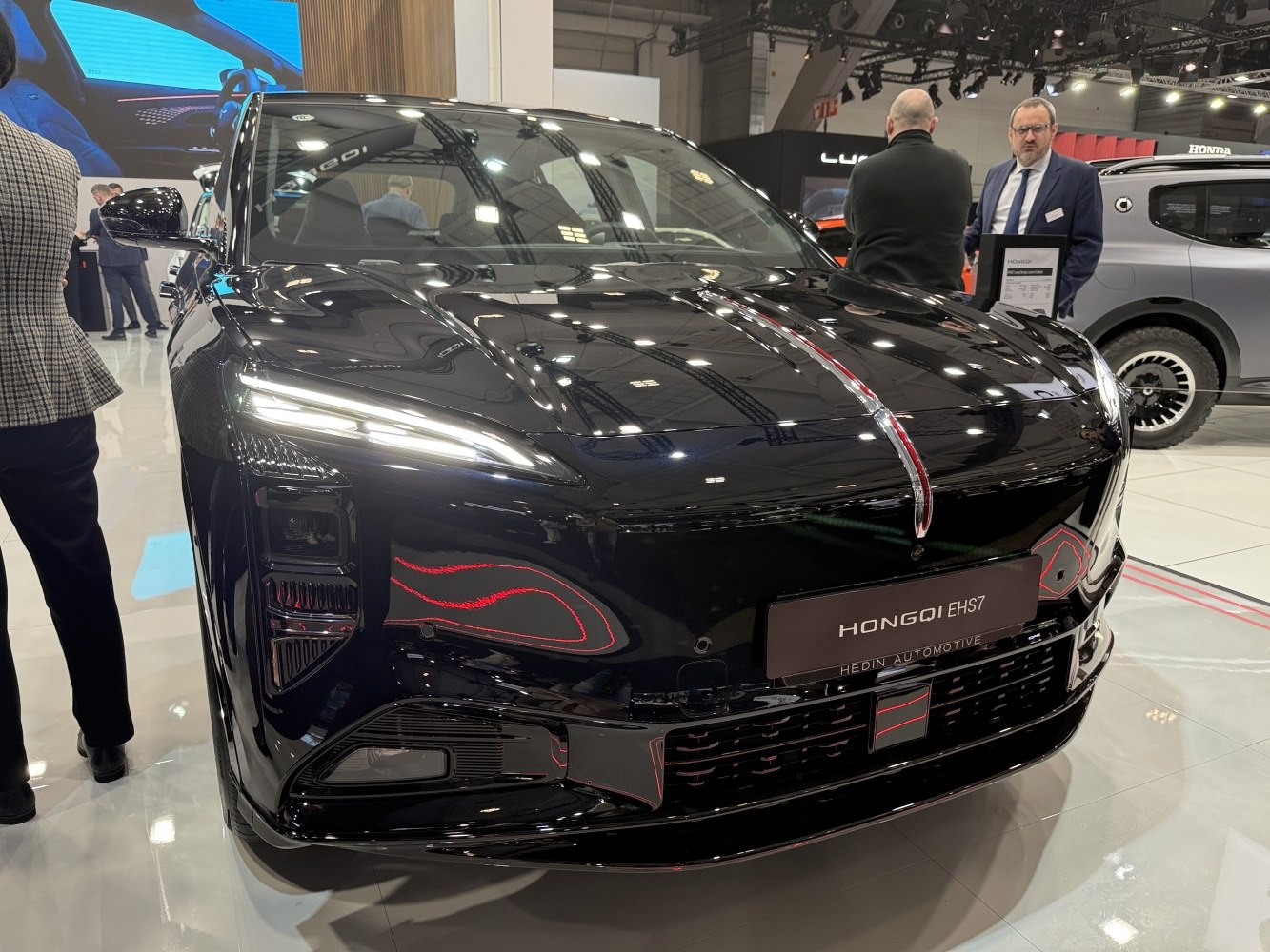 Front view of a sleek black vehicle with LED headlights