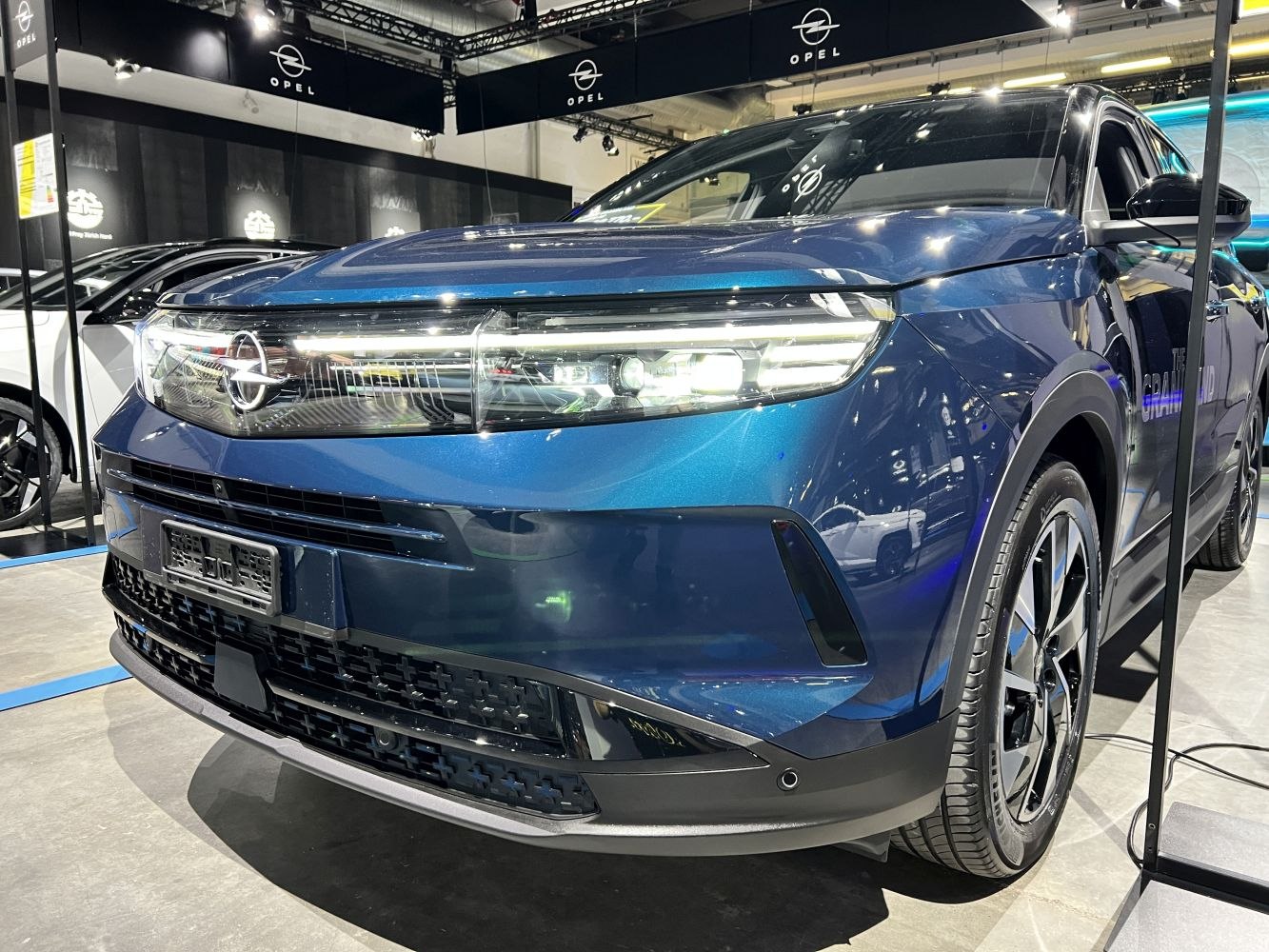 Front view with LED headlights and modern grille on blue SUV