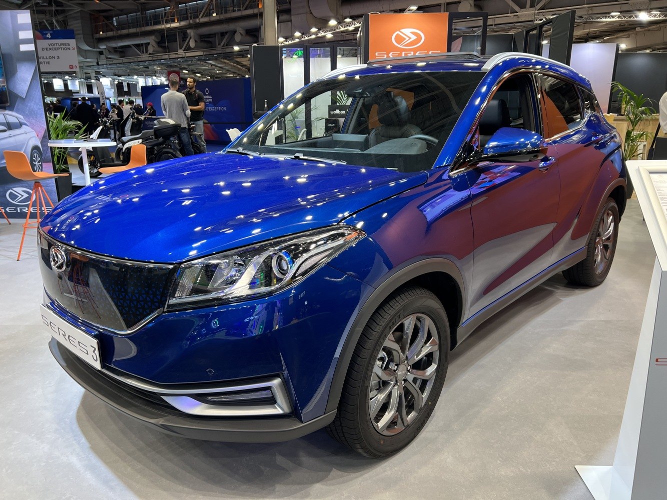 Blue electric SUV with LED headlights and aerodynamic design.