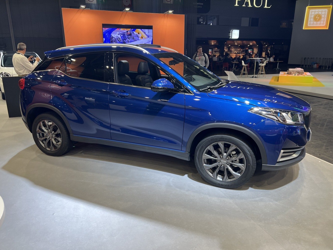 Blue compact SUV side profile with alloy wheels and tinted windows