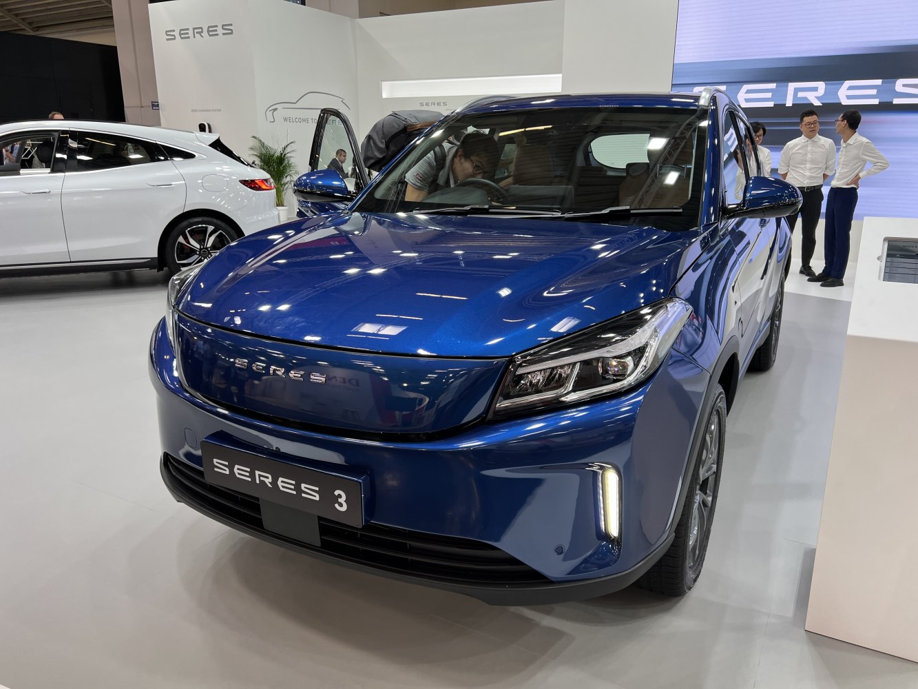 Sleek electric SUV front with modern LED headlights and blue exterior