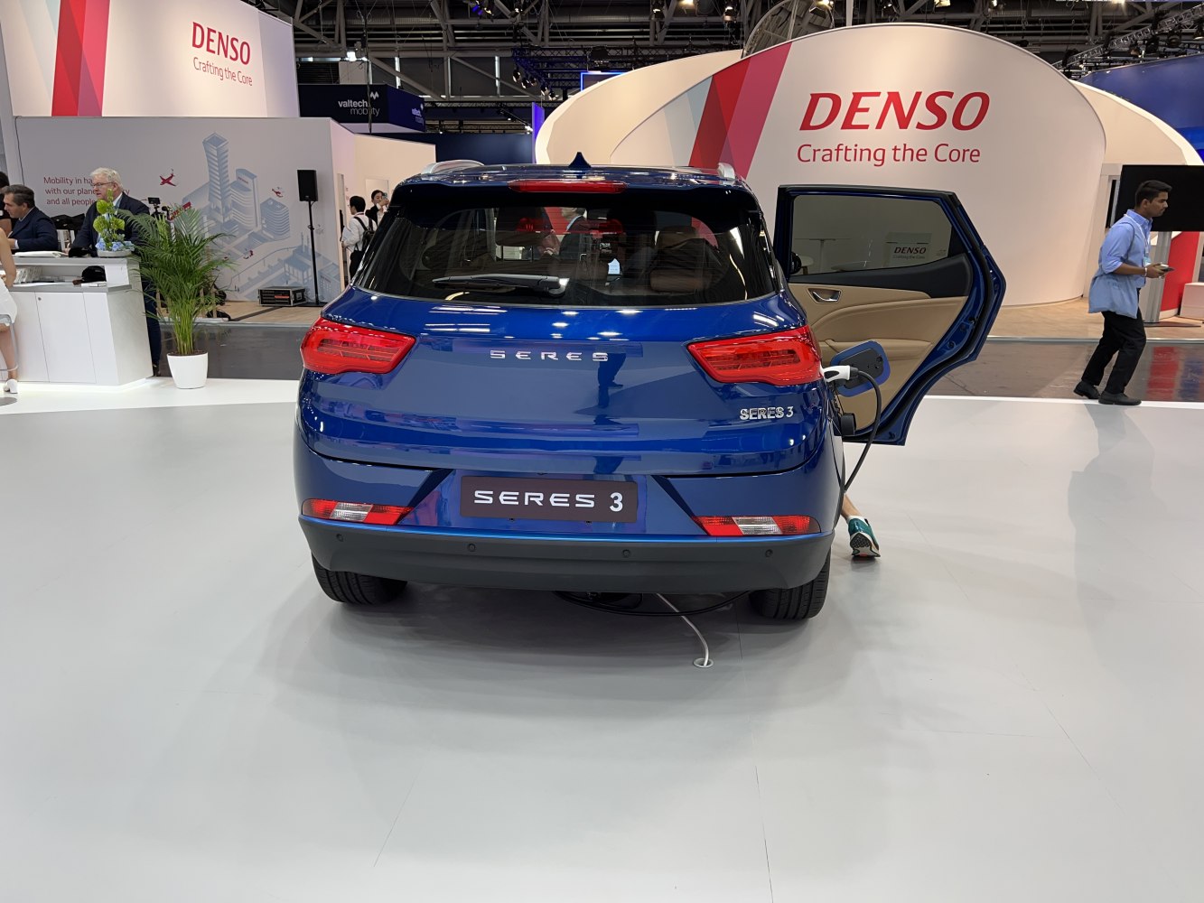 Rear view of electric SUV with charging plug