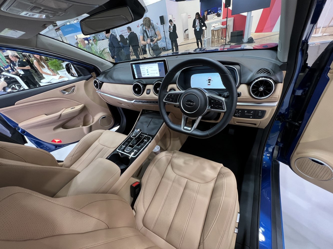 Interior with digital instrument cluster, touchscreen dashboard, beige leather seats