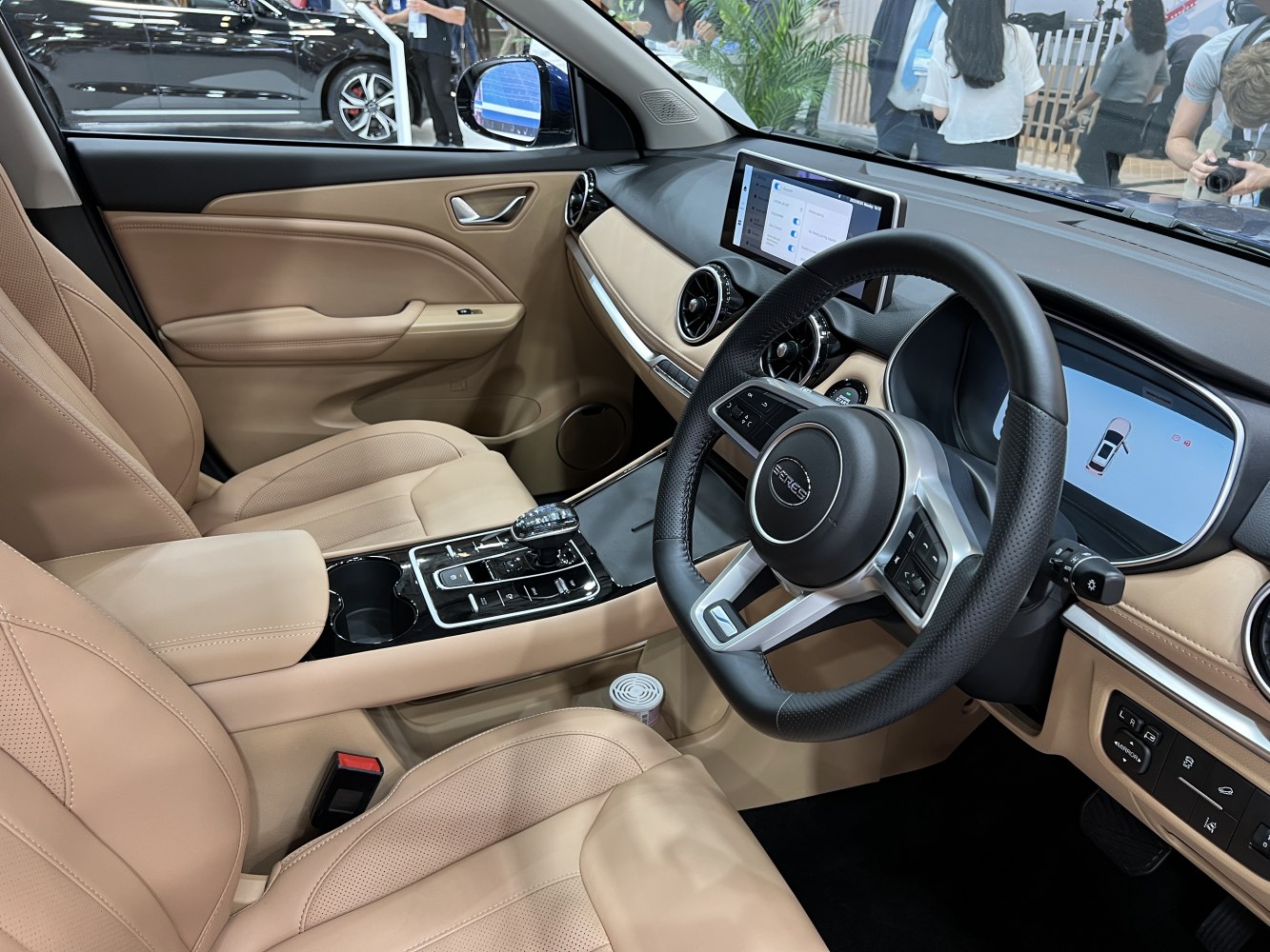 Beige leather interior with digital displays and steering wheel controls