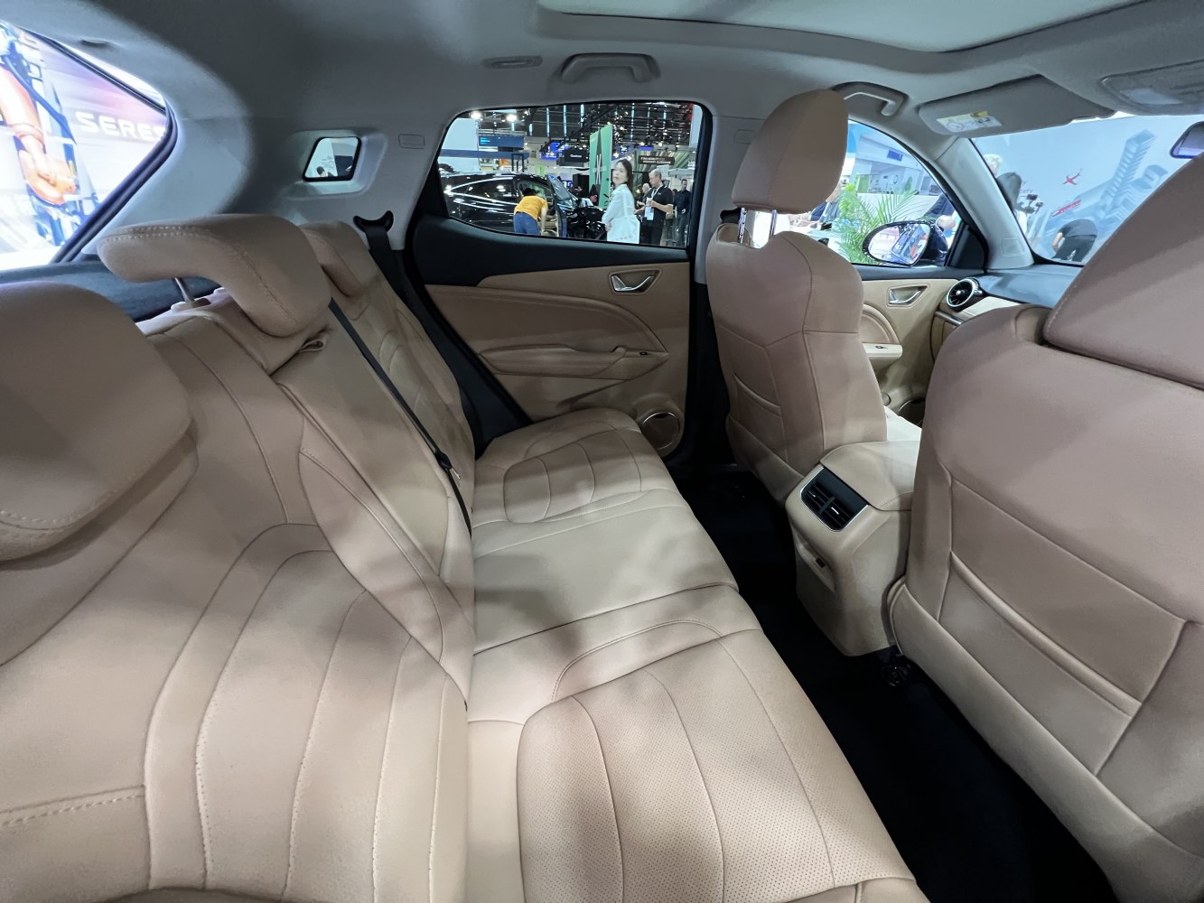 Spacious rear beige leather seats with rear air vents and modern cabin design