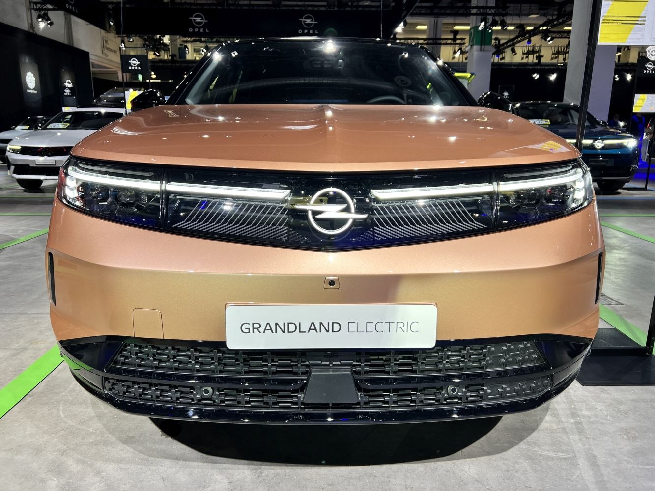 Front view with integrated LED headlights and central emblem on modern electric vehicle.